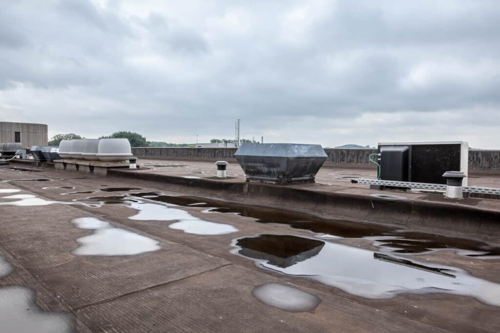 A flat top roof on a commercial building that requires recurring building maintenance.