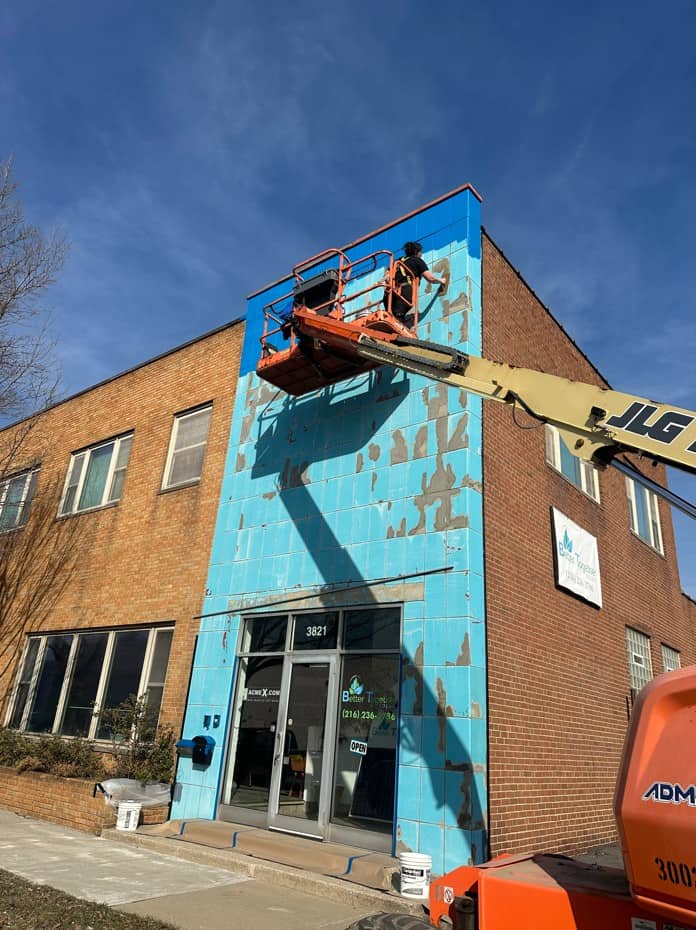 A Southwest Companies employee working on preventative painting for a commercial building on Prospect Avenue in Cleveland, Ohio.