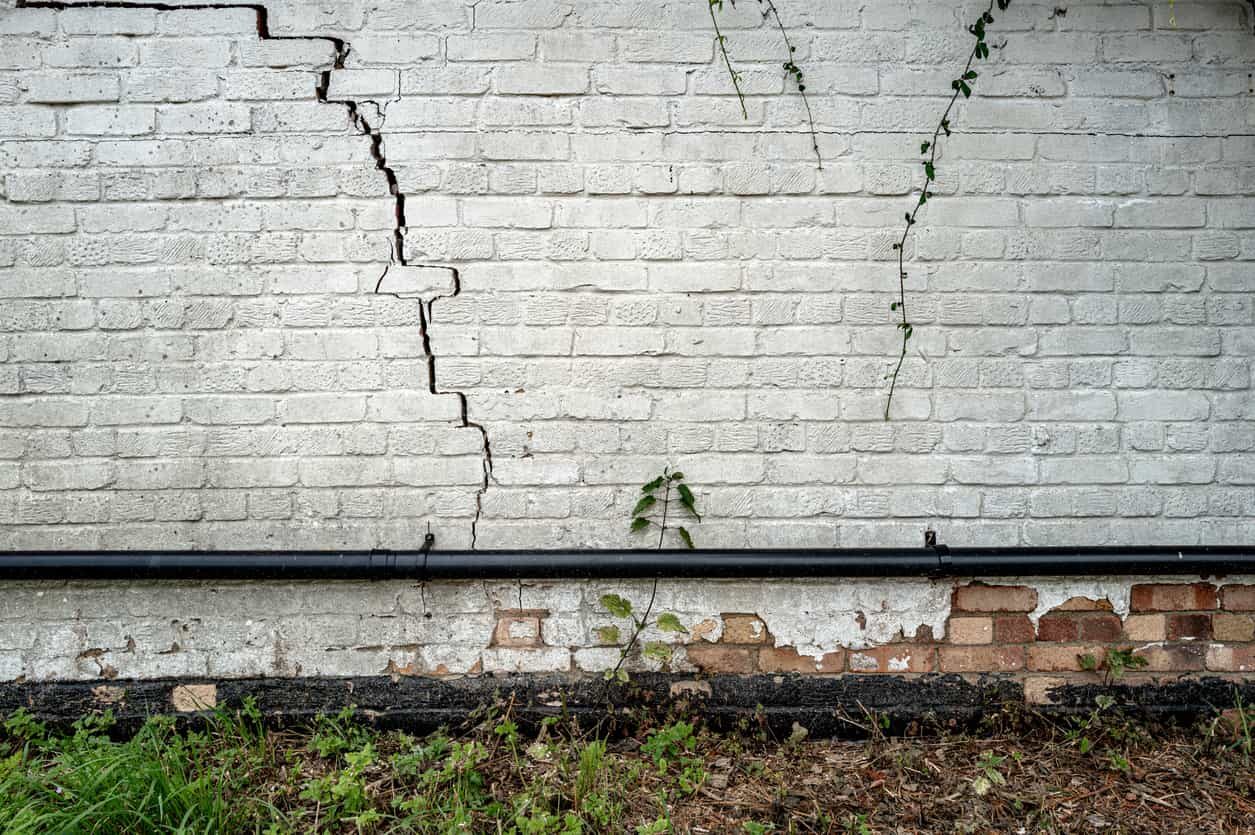 A commercial building’s wall with cracks from freeze-thaw damage.