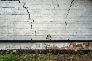 A commercial building’s wall with cracks from freeze-thaw damage.