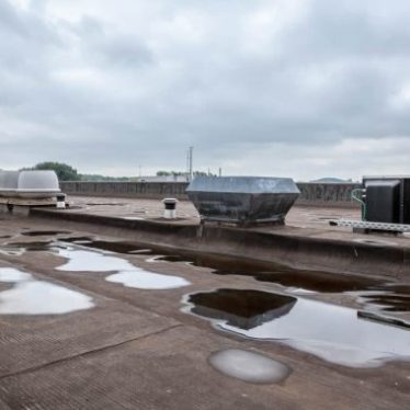 Roof with puddles of rain water