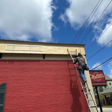 A Southwest Companies employee performing preventative commercial painting for a business in Olmsted Falls, Ohio.